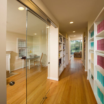 Hallway with glass wall and built-ins