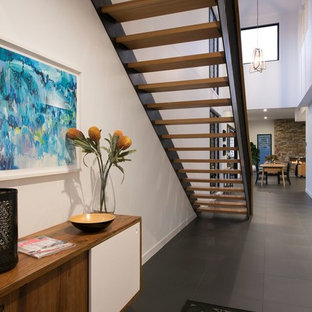 Photo of a contemporary hallway in Brisbane with white walls and grey floor.