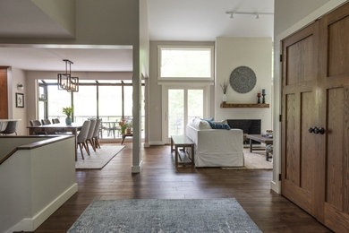 Example of a mid-sized transitional dark wood floor and brown floor hallway design in Providence with gray walls