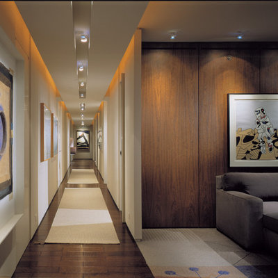 Trendy dark wood floor hallway photo in Chicago with white walls