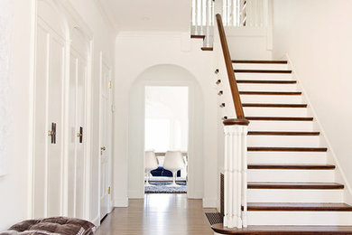 Hallway - transitional medium tone wood floor and brown floor hallway idea in San Francisco with white walls