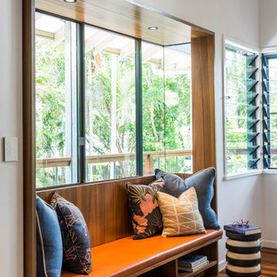 Photo of a mid-sized contemporary hallway in Brisbane with white walls, medium hardwood floors and brown floor.