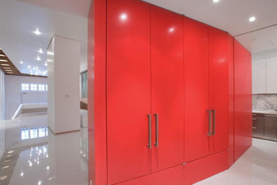 Example of a large minimalist white floor hallway design in New York with red walls