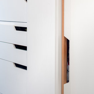 Small danish light wood floor hallway photo in Portland with white walls