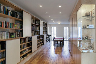 Hallway - medium tone wood floor hallway idea in New York with white walls