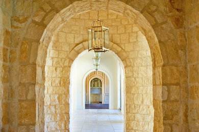 Example of a large tuscan limestone floor hallway design in Raleigh