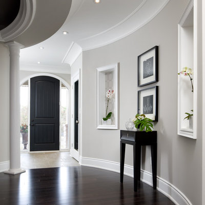 Transitional brown floor hallway photo in Toronto with gray walls