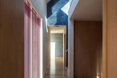 Hallway - modern hallway idea in London with beige walls