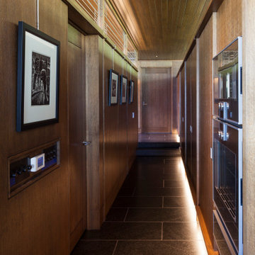 Lac La Belle - Modern Brick Lake Home Gallery Style Wood Wall Hallway