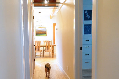 Inspiration for an eclectic light wood floor hallway remodel in San Francisco with yellow walls