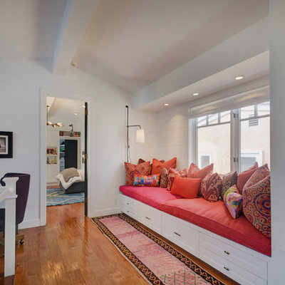 Hallway - transitional medium tone wood floor and brown floor hallway idea in Los Angeles with white walls