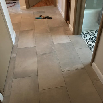 Main bathroom remodel with floor tile and baseboard trim work