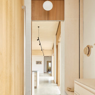 This is an example of a mid-sized contemporary hallway in Perth with concrete floors, grey floor and beige walls.