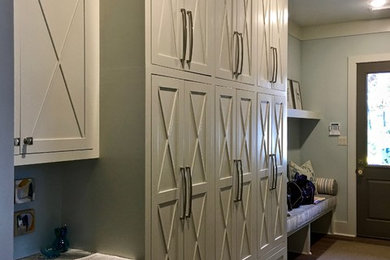 Example of a mid-sized transitional dark wood floor and brown floor hallway design in Little Rock with blue walls