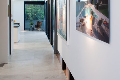 Свежая идея для дизайна: коридор в современном стиле с белыми стенами и полом из травертина - отличное фото интерьера