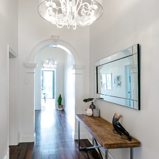 Photo of a contemporary hallway in Adelaide with white walls, dark hardwood floors and brown floor.