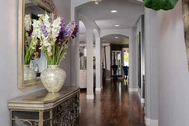 Hallway - mid-sized traditional dark wood floor hallway idea in Sacramento with gray walls