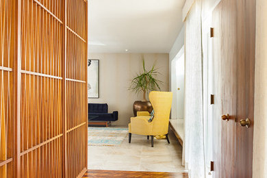 Example of a mid-sized minimalist light wood floor hallway design in Los Angeles with white walls