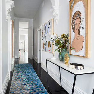 Contemporary hallway in Melbourne with white walls, painted wood floors and black floor.