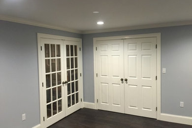 Hallway - large traditional dark wood floor and brown floor hallway idea in Boston with blue walls