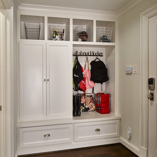 Photo of a small transitional hallway in Dallas with beige walls, medium hardwood floors and brown floor.