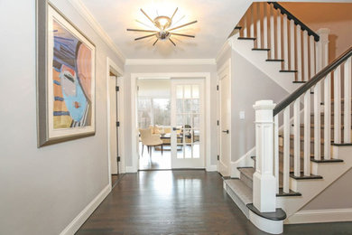 Mid-sized transitional dark wood floor hallway photo in New York with gray walls