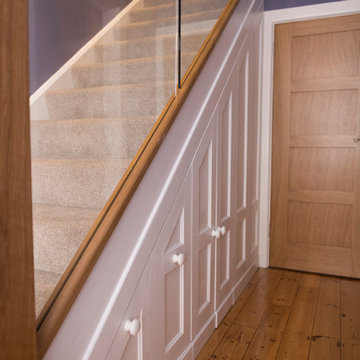 Oak and glass staircase renovation with under stairs storage