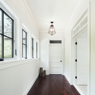 Hallway - scandinavian dark wood floor hallway idea in New York with white walls