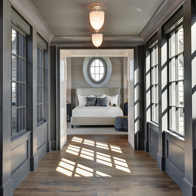 Example of a beach style medium tone wood floor hallway design in Charleston with gray walls