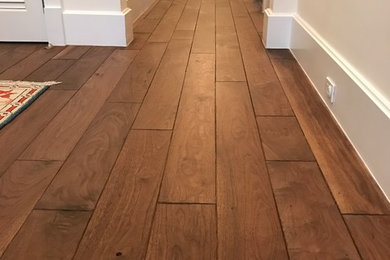 Hallway - large traditional medium tone wood floor and brown floor hallway idea in Miami