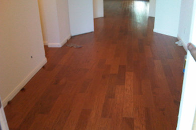 Example of a mid-sized medium tone wood floor hallway design in Austin with beige walls