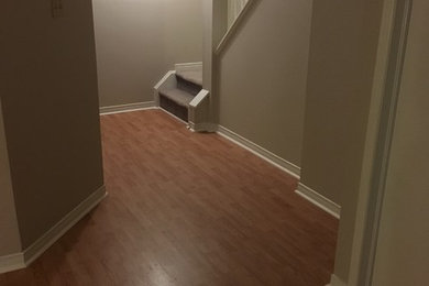 Hallway - mid-sized traditional brown floor and medium tone wood floor hallway idea in Toronto with gray walls