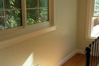 Mid-sized trendy medium tone wood floor hallway photo in Dallas with gray walls