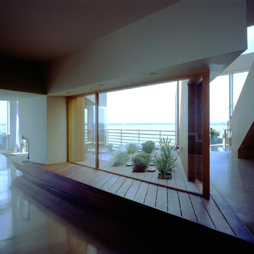 Outdoor terrace extends into the gallery as a wooden bench.