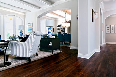Example of a mid-sized transitional dark wood floor and brown floor hallway design in Miami with gray walls