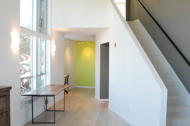 Mid-sized trendy medium tone wood floor hallway photo in Toronto with multicolored walls