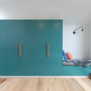 Photo of a contemporary hallway in Melbourne with white walls, light hardwood floors and beige floor.