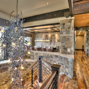 Idée de décoration pour un très grand couloir chalet avec un mur beige et un sol en bois brun.