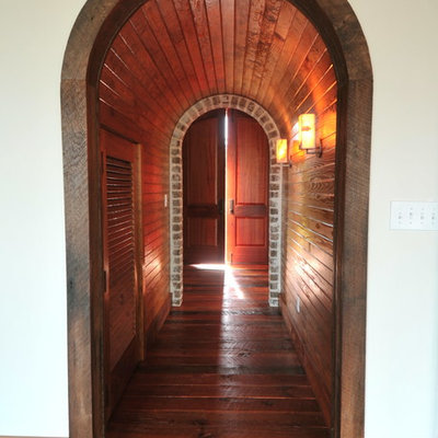Example of a tuscan dark wood floor hallway design in Charleston