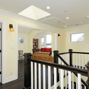 Inspiration for a craftsman dark wood floor hallway remodel in San Francisco with yellow walls