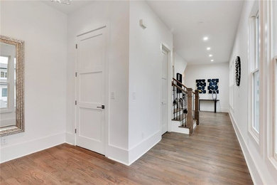 Inspiration for a mid-sized modern medium tone wood floor and gray floor hallway remodel in Atlanta