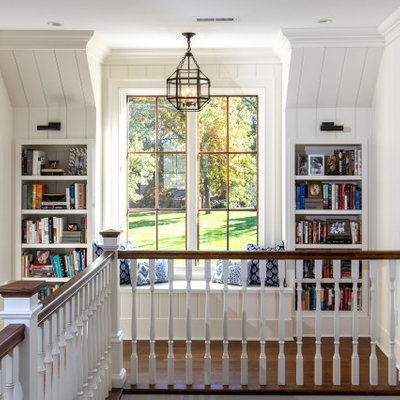 Large cottage medium tone wood floor and brown floor hallway photo in Other with white walls