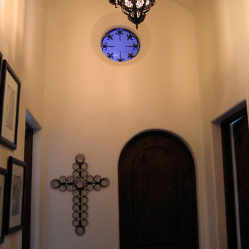 Spanish Style Hall with Round Window and Wrought Iron Grille