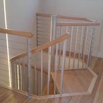 Spiral stairs with wood maple treads and handrail.