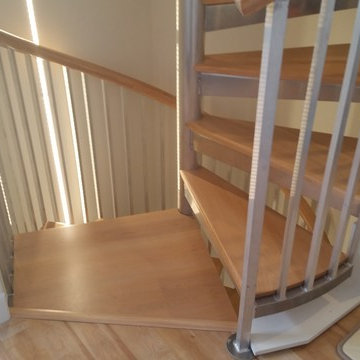 Spiral stairs with wood maple treads and handrail.