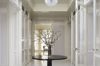 Hallway - large contemporary light wood floor and white floor hallway idea in San Francisco with white walls