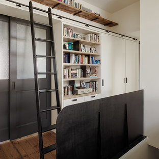 Mid-sized danish medium tone wood floor hallway photo in New York with white walls