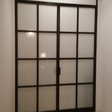 Steel and glass french doors with transom