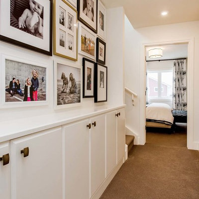 Transitional carpeted hallway photo in Other with white walls