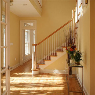 Sunny hallway and staircase in painted yellow room